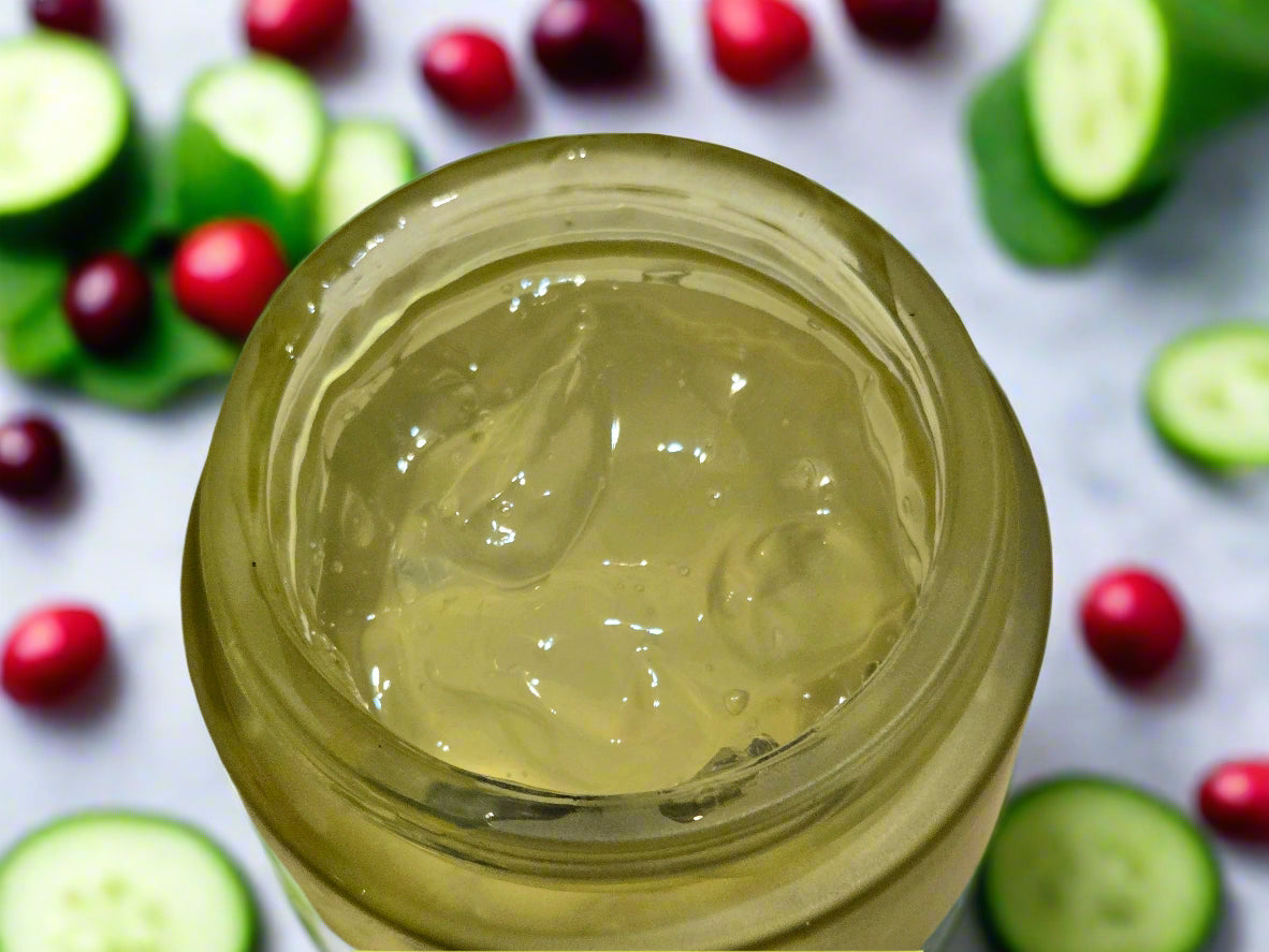 Jar of clear gel or cream on a wooden surface