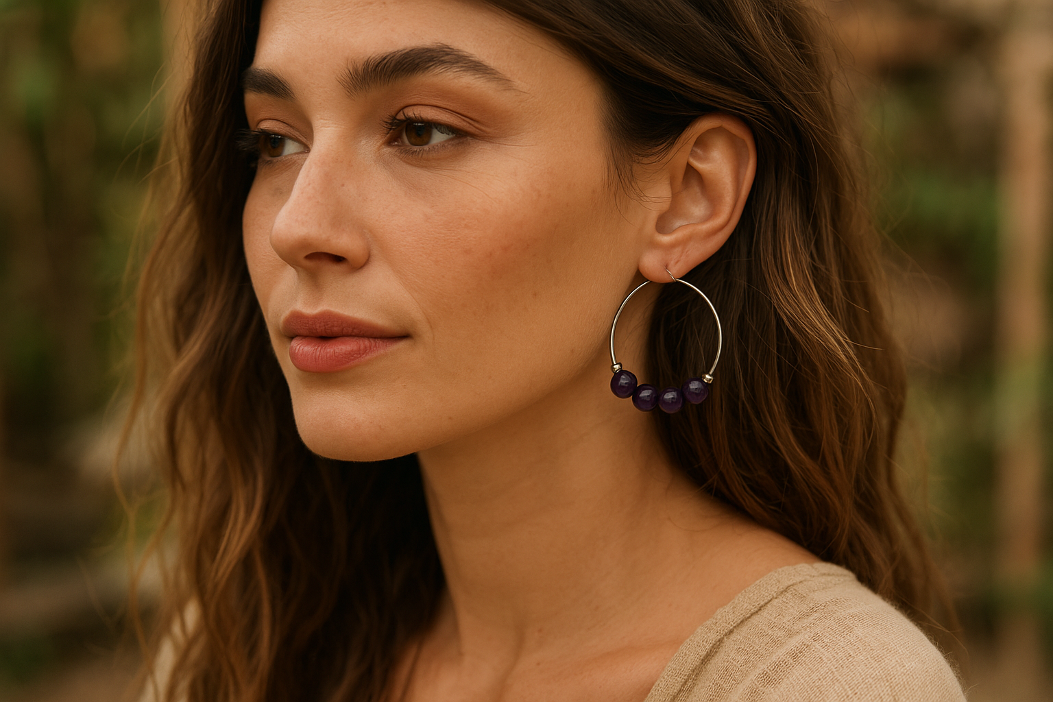 Realistic boho model wearing 2-inch purple amethyst hoop earrings with correct bead count