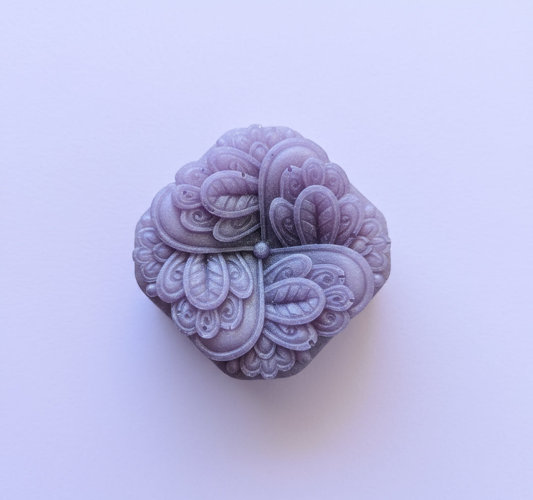 Purple floral design on a textured beige surface