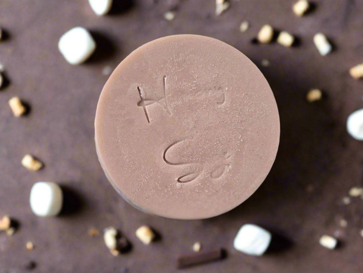 Round pink soap bar with 'Harmony and SAge' branding on a marble surface