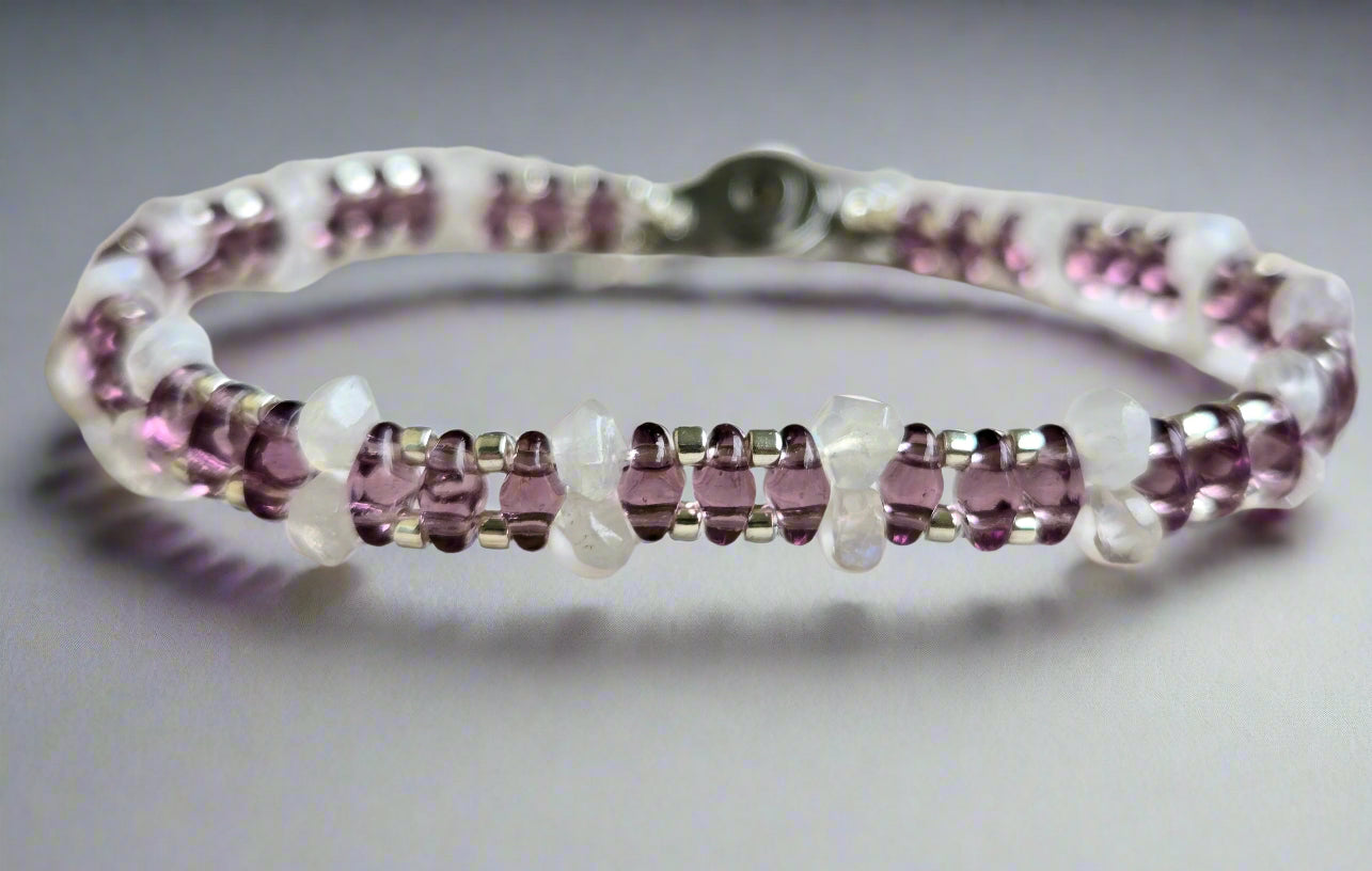 Bracelet with purple gemstones on a wooden surface