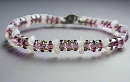 Bracelet with purple gemstones on a wooden surface