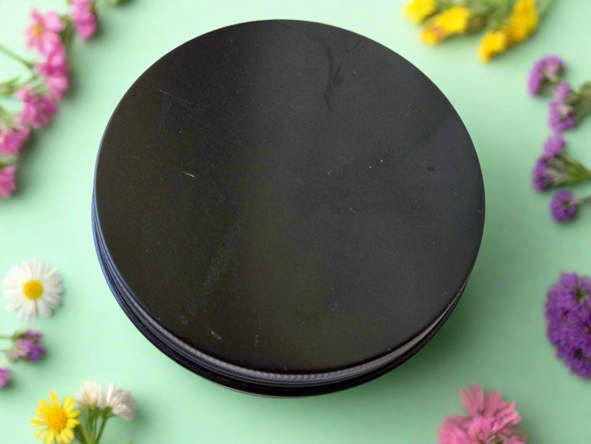 Stack of black round objects on a wooden surface