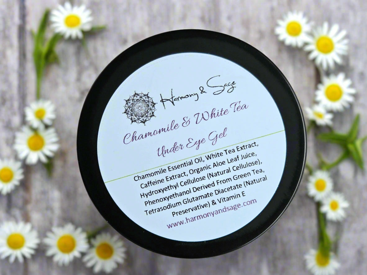 Container of Chamomile & White Tea Under Eye Gel with label on a wooden surface