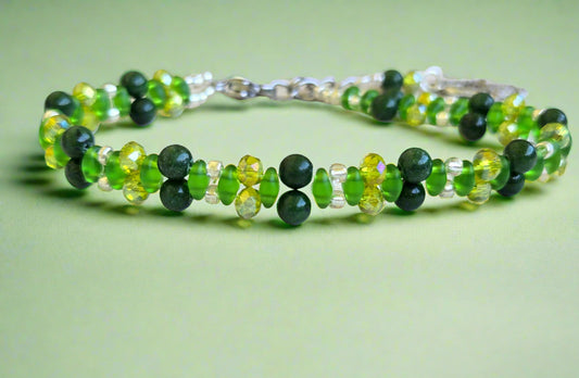 Green beaded bracelet on a light wooden surface